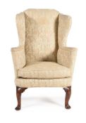 A GEORGE I WALNUT AND UPHOLSTERED WING ARMCHAIR, CIRCA 1725