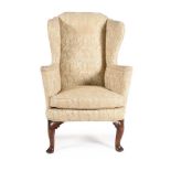 A GEORGE I WALNUT AND UPHOLSTERED WING ARMCHAIR, CIRCA 1725