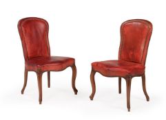 A SET OF EIGHTEEN WALNUT AND LEATHER UPHOLSTERED DINING CHAIRS, IN GEORGE III STYLE