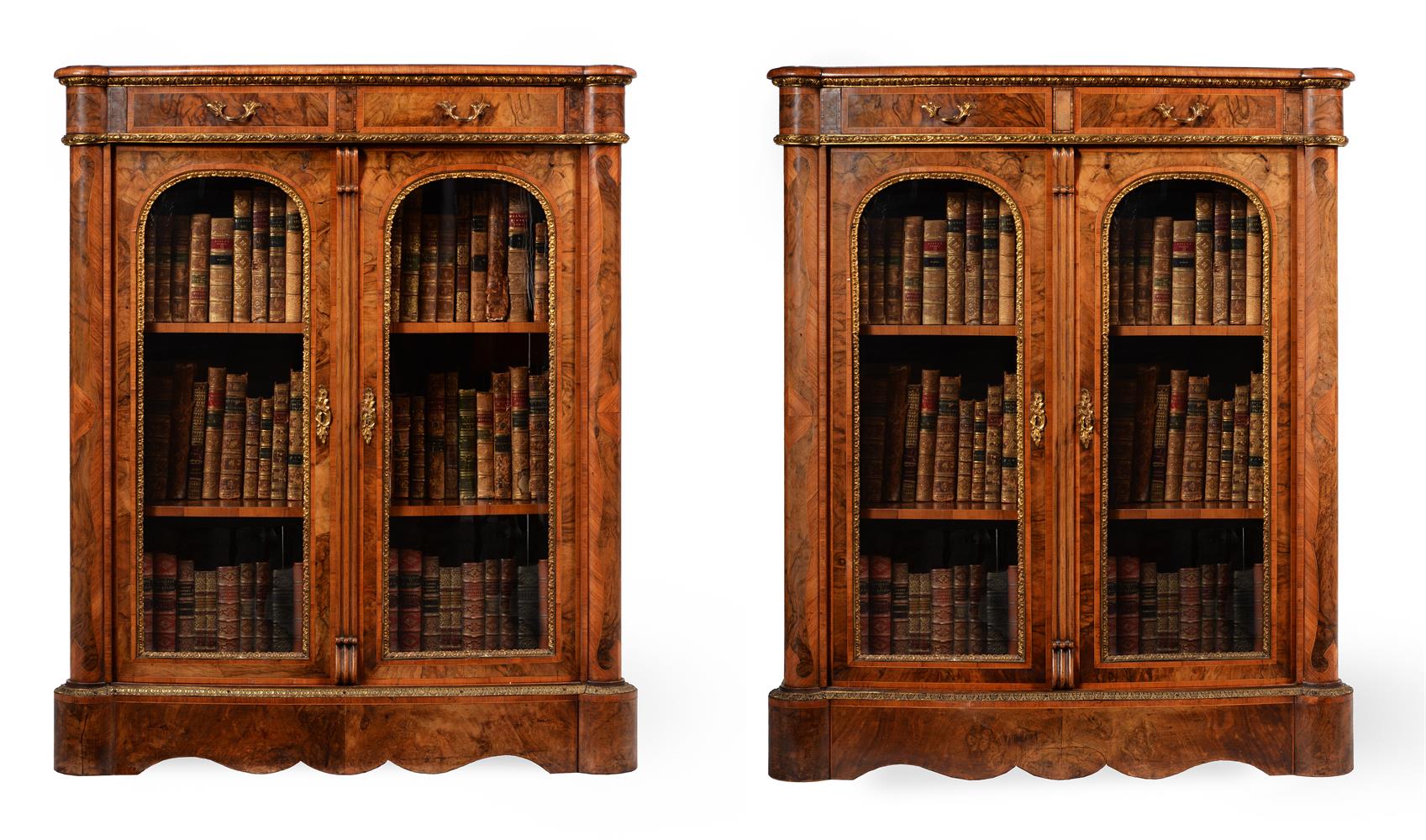 A PAIR OF VICTORIAN FIGURED WALNUT, WALNUT CROSSBANDED AND GILT METAL MOUNTED BOOKCASES