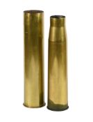 Two polished brass shell cases.