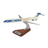 An aircraft manufacturers desk top model of a McDonnell Douglas MD90 passenger plane