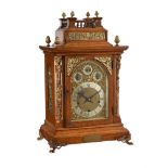 AN EDWARDIAN GILT BRASS MOUNTED OAK QUARTER-CHIMING BRACKET CLOCK