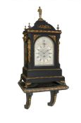 A LATE VICTORIAN BRASS MOUNTED EBONISED QUARTER-CHIMING BRACKET CLOCK WITH WALL BRACKET