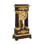 A FRENCH CHARLES X ORMOLU AND PATINATED BRONZE PORTICO MANTEL CLOCK