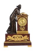A FRENCH EMPIRE PATINATED BRONZE AND ORMOLU MOUNTED ROSSO FRANCIA MARBLE FIGURAL MANTEL CLOCK