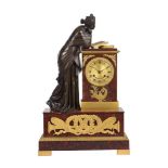 A FRENCH EMPIRE PATINATED BRONZE AND ORMOLU MOUNTED ROSSO FRANCIA MARBLE FIGURAL MANTEL CLOCK