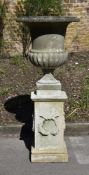 A MARBLE CAMPANA URN ON A LIMESTONE PEDESTAL BASE, THE URN EARLY/MID 19TH CENTURY