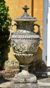 A PAIR OF MONUMENTAL COMPOSITION STONE LIDDED VASES, MID 20TH CENTURY