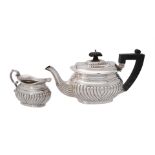 A silver half gadrooned oblong tea pot and cream jug by A. & J. Zimmerman
