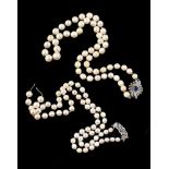 A cultured pearl necklace with a mid 20th century sapphire and diamond clasp