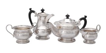 A silver circular four piece tea service by G. Bryan & Co.