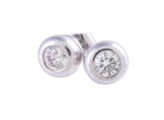 A pair of diamond single stone ear studs