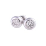 A pair of diamond single stone ear studs