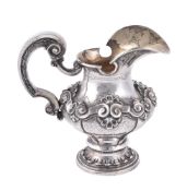 A Portuguese silver coloured baluster cream jug