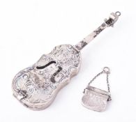 A William IV silver purse vinaigrette and a German silver model of a cello