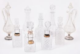 A collection of nine cut glass decanters