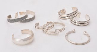 A collection of silver and silver coloured bangles