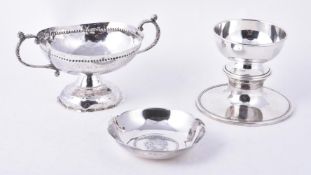 Four silver or silver coloured items