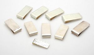 A collection of silver hammered rectangular money clips