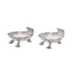 A pair of George II silver shell shaped butter dishes by Christian Hillan