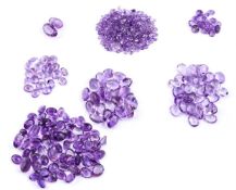† A large packet of oval and circular cut amethysts
