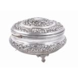 An Egyptian silver coloured circular hinged box and cover