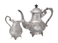 An Indian silver coloured baluster tea pot and cream jug