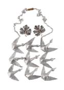 The Flight by Jef Claerhout, a silver coloured abstract bird necklace