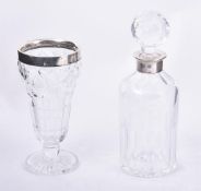 A silver mounted cut glass decanter by K. M. Silver