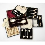 Six cased sets of silver spoons