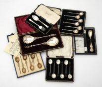 Six cased sets of silver spoons