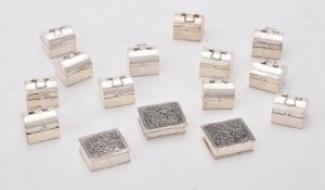 A collection of silver pill boxes