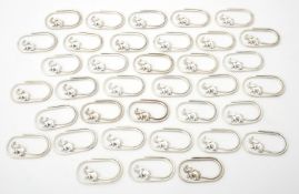 A collection of silver coloured oval clips