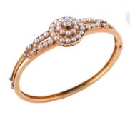 A late Victorian diamond and half pearl hinged bangle