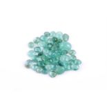 † A packet of oval cabochon emeralds