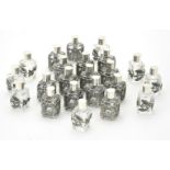 Twenty two glass scent bottles with silver coloured mounts