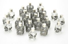 Twenty two glass scent bottles with silver coloured mounts