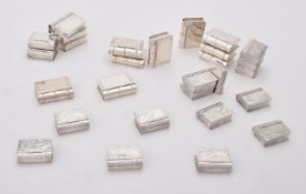 A collection of silver and silver coloured book shaped boxes