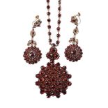 A late 19th century Bohemian garnet necklace and similar ear pendants