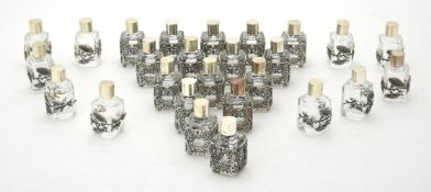 Twenty six glass scent bottles with silver coloured mounts