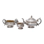 Y A George IV silver three piece circular tea set by S. C. Younge & Co.