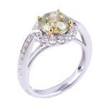 A laser drilled and fracture filled yellow diamond and diamond cluster ring