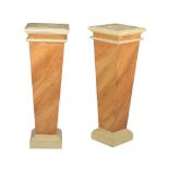 A pair of simulated marble pedestals