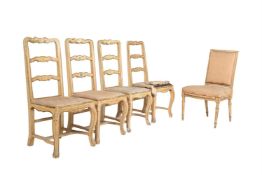A set of four cream and polychrome painted side chairs