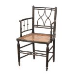 A 19th century black painted armchair