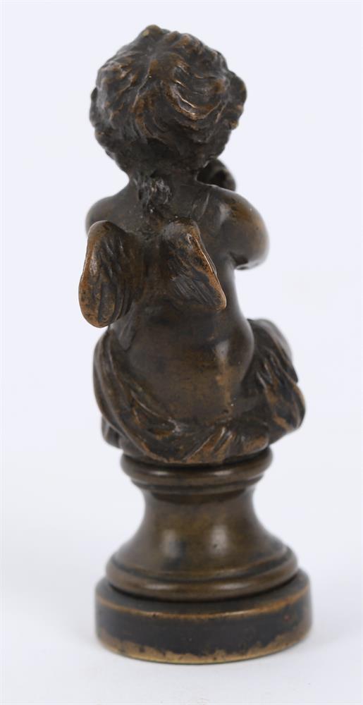 A small bronze of a seated child wrestling a dolphin and a bronze figural seal - Image 6 of 11