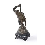 A bronze figure of a great ape with club