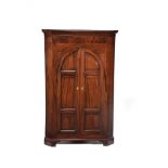 A mahogany standing corner cupboard