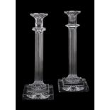 A pair of press moulded clear glass columnar candlesticks by William Yeoward